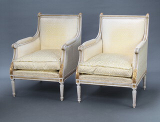 A pair of Empire style white and gilt painted armchairs upholstered in yellow material, raised on turned and fluted supports 90cm h x 66cm w x 66cm d (seat 36cm x 34cm) 