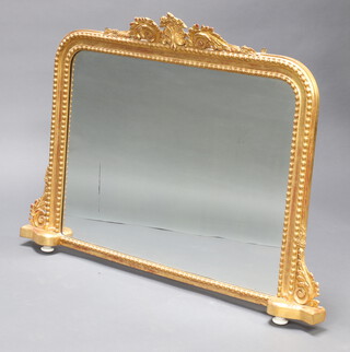 A 19th Century D shaped plate over mantel mirror contained in a decorative gilt frame with porcelain bun feet 97cm h x 131cm w x 9cm d