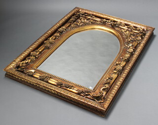 A Victorian style arched plate mirror contained in a decorative gilt resin frame 138cm h x 100cm w x 10cm d (section of resin missing to the right hand side) 