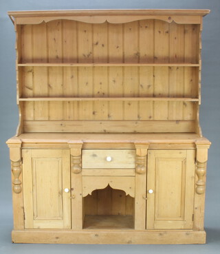 A Victorian style dog kennel pine dresser, the raised back with moulded cornice above 3 shelves, the base fitted a drawer above recess flanked by a pair of cupboards 262cm h x 170cm w x 49cm d (some light scratches and water marks in places)  