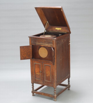 A 1930's Fullotone gramophone contained in an oak case 100cm h x 50cm w x 44cm d (water stains to the top) 
