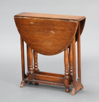 A light oak drop flap tea table, raised on turned supports 51cm h x 49cm w x 12cm d 