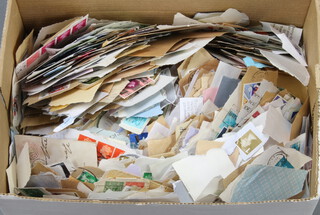 A cardboard bank box containing a collection of loose GB stamps, mostly on paper
