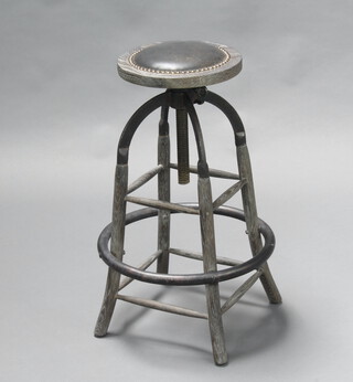 A Mid-Century industrial iron and oak circular adjustable stool 67cm h x 28cm diam. 
