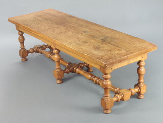 A 17th Century style oak bench/coffee table raised on turned cup and cover supports with H framed stretcher 48cm h x 160cm l x 53cm w 