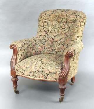 A William IV mahogany show frame armchair upholstered in green tapestry material, raised on turned and reeded supports with brass caps 94cm h x 85cm w x 60cm d (seat 37cm x 45cm) 