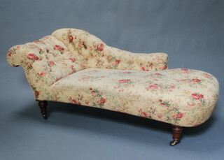 A Victorian chaise longue upholstered in buttoned floral material, raised on turned supports with ceramic casters 72cm h x 191cm w x 74cm d (seat 130cm x 52cm) 