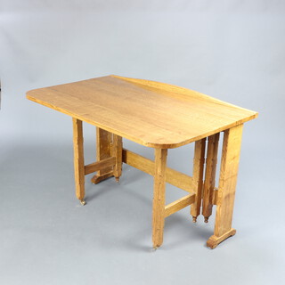 An Art Deco style light oak drop flap gateleg table fitted 1 flap, raised on shaped supports 76cm h x 110cm w x 9cm when closed x 70cm when open 