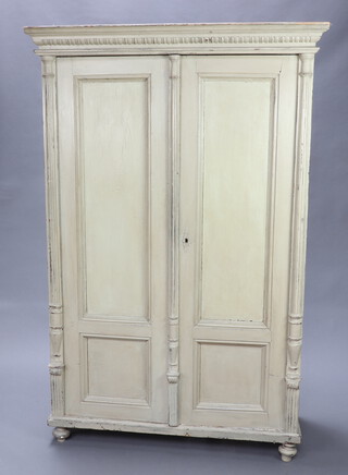 A 19th Century green painted French wardrobe with moulded cornice, enclosed by panelled doors 182cm h x 118cm w x 56cm d 
