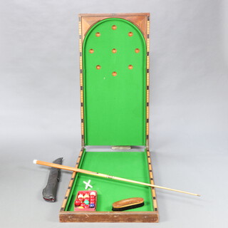A 19th Century table top folding bagatelle/billiard table, when folded 122cm l x 64cm w, when open 244cm l x 64cm w, together with a set of billiard balls, cue and brush 