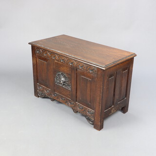 A 1920's carved oak coffer with hinged lid and panelled decoration 54cm h x 86cm w x 41cm d 