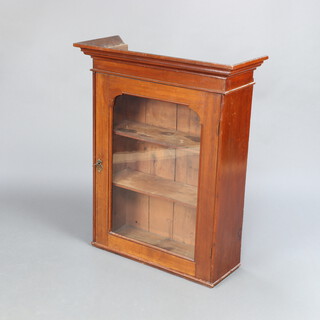 A Victorian walnut display cabinet with moulded cornice, fitted shelves enclosed by arched panelled doors 89cm h x 73cm w x 29cm d 