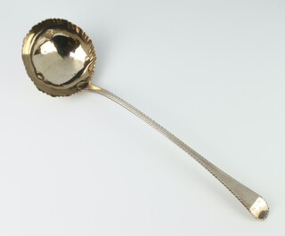 A George III silver ladle with bright cut decoration and engraved monogram London 1771, 142 grams 