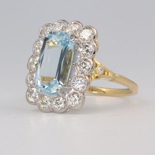 A yellow metal aquamarine and diamond ring, the centre emerald cut stone approx. 2.5ct, the brilliant cut diamonds 1.1ct, size m, 5.6 grams 