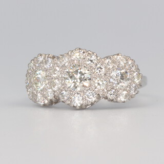 A white metal stamped plat. triple cluster diamond ring approx. 1.85ct, 4.9 grams, size O 