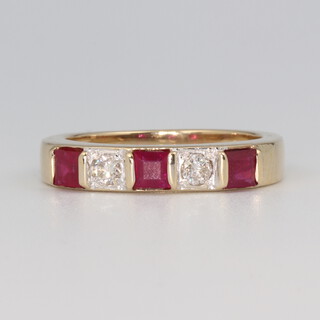 A 9ct yellow gold diamond and ruby ring, the 2 brilliant cut diamonds each approx. 0.05ct, the 3 princess cut rubies each 0.02ct, 3.4 grams, size L  