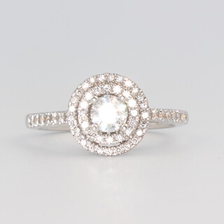 An 18ct white gold brilliant cut diamond halo ring 0.61ct, size L, 3.3 grams 