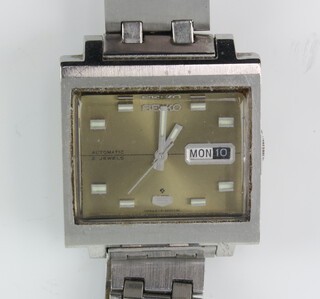 A gentleman's steel cased Seiko automatic day date wristwatch contained in a square case and a steel Seiko bracelet  