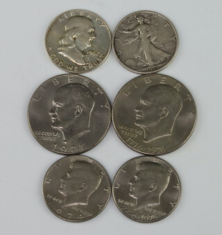 Four American half dollars 1935, 1962, 1974, 1976, a 1976 and a 1977 dollar 