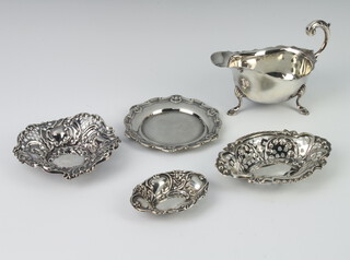 A silver sauce boat with S scroll handle on pad feet, Birmingham 1939, a Chippendale style dish and 3 repousse bon bon dishes, 174 grams 