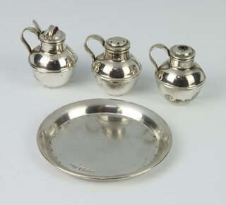 A novelty silver condiment in the form of Jersey cream jugs Birmingham 1956, together with a similar circular tray, gross weight 128 grams 