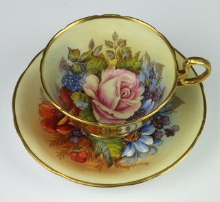 A rare Aynsley teacup and saucer decorated with Roses by Joseph A Bailey (active 1937-1974) the cup with gilt exterior the saucer marked C the cup marked ??087  PLEASE NOTE - VIEWING OF THIS LOT IS BY PRE-BOOKED APPOINTMENT ONLY 