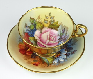 A rare Aynsley teacup and saucer decorated with Roses by Joseph A Bailey (active 1937-1974) the cup with gilt exterior the saucer marked C the cup marked with 4 dots PLEASE NOTE - VIEWING OF THIS LOT IS BY PRE-BOOKED APPOINTMENT ONLY 