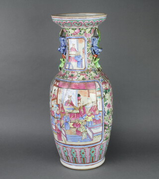 A late 19th Century famille rose baluster vase with Shi Shi handles and panels of figures at pursuits in pavillion interiors on a ground of flowers and insects 61cm 