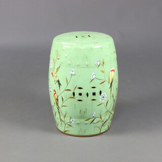 A 20th Century Chinese green porcelain barrel garden seat decorated with exotic birds amongst flowers 45cm 