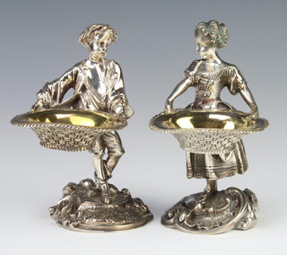 A pair of Victorian style cast silver plated salts in the form of a standing lady and gentleman, raised on rococo bases 14cm 