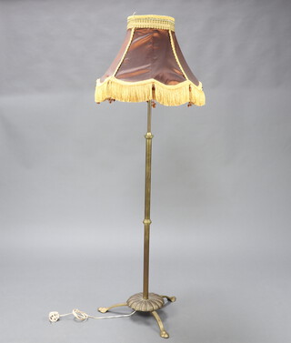 A 19th Century adjustable brass standard lamp raised on shaped base 124cm h 