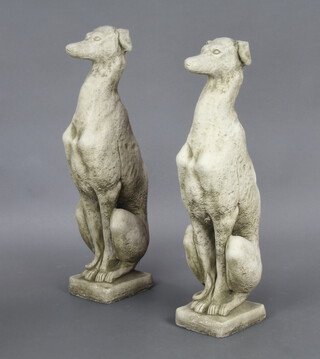 A pair of concrete garden figures of seated greyhounds 74cm h 