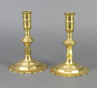 A pair of 17th/18th Century polished brass petal base candlesticks 16cm h x 10cm