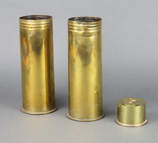 A cylindrical brass Trench Art inkwell with hinged lid 5cm x 7cm (hinge f) together with a Continental brass shell case marked Polte 1917 and 1 other 