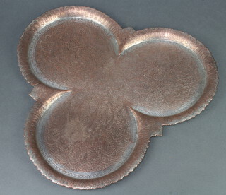 A Persian engraved copper clover shaped tray 39cm x 43cm 
