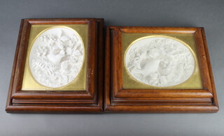 A pair of Victorian plaster relief plaques of birds contained in oak cushion shaped frames, one with impressed signature and date - E Gomm 1863 36cm x 32cm 