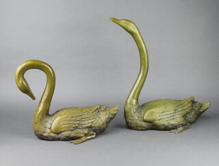 A pair of bronze figures of swans 33cm x 40cm x 23cm and 30cm x 20cm x 35cm 