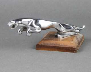 A Jaguar car mascot mounted on a wooden stand 20cm x 3cm, base marked 710091/1 Web 
