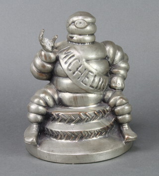 A Michelin figure of Bibendum sitting on 2 tyres 22cm x 17cm (possibly missing spanner to raised hand) 