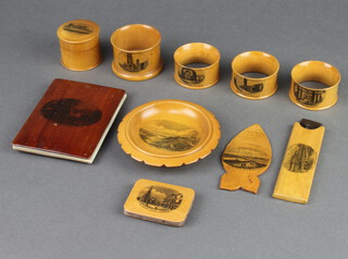 A Mauchline Ware bookmark decorated Saddleback Derwent water, a circular pin tray decorated cliffs Felixstowe, a cylindrical jar and cover decorated Dover Crescent, ditto vase Ely from the River, rectangular pin cushion St John's Church Lowestoft, bookmark St Ives Cornwall, comb case The Grand Margate, 3 napkin rings - Blackfriars Chapel St Andrews, College Church St Andrews and West Port St Andrews