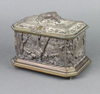 A 19th Century gilt metal lozenge shaped casket with hinged lid, the top decorated a seated hound, the panels decorated hunting scenes, raised on bun feet 11cm x 18cm x 12cm 