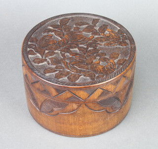 A cylindrical Japanese carved hardwood jar and cover 10cm x 17cm 