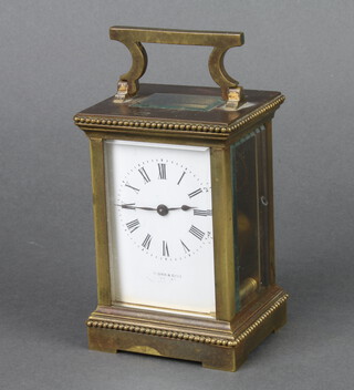 A 19th Century French 8 day carriage timepiece with enamelled dial and Arabic numerals contained in a gilt metal case, the dial marked P.Orr & Sons, complete with key 11cm x 8cm x 7cm 