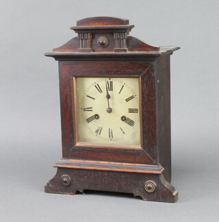 A 19th Century Continental striking mantel clock, the 14cm circular dial with Roman numerals contained in an oak case 36cm h x 28cm w x 14cm d 
