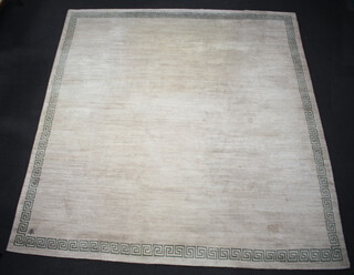 A mushroom and green ground Nepalese hand knotted carpet with green Grecian key decoration to the edge 380cm x 359cm, with Cross of Lorraine signature to the corner, labelled 100% pure wool pile, fine quality Tibetan wool, carded and spun by hand, hand knotted in Nepal, natural dyes 