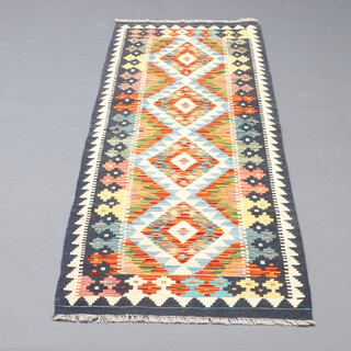 A black, yellow and blue ground Chobi Kilim runner with 4 diamonds to the centre 190cm x 64cm 