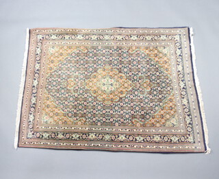 A blue and green ground North West Persian silk rug with central medallion and all over design 139cm x 114cm 