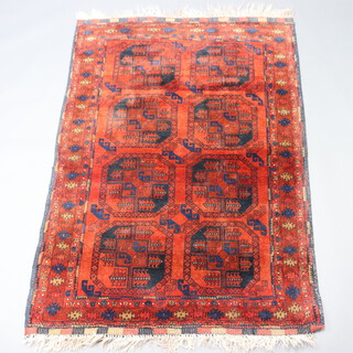 A red and blue ground Afghan rug with 8 octagons to the centre 186cm x 128cm 