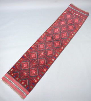 A red and blue ground Meshwani runner with 21 octagons to the centre 274cm x 64cm 