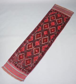 A red ground Meshwani runner with 14 diamonds to the centre 247cm x 63cm 